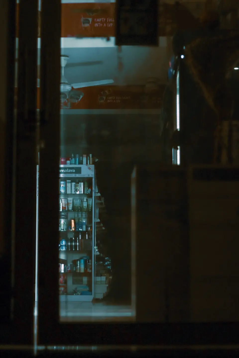 A shop after hours, lit only by what it's selling.